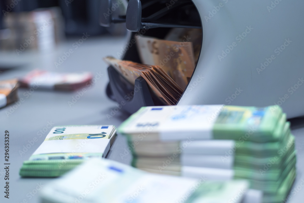 Bank employees sorting and counting money inside bank vault. Bank employees sorting and counting money inside bank vault.
