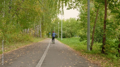 Wallpaper Mural Teenager boy riding on skateboard in city park back view. Rear view boy teenager skateboarding on path in autumn park. Boy training on long board outdoor Torontodigital.ca