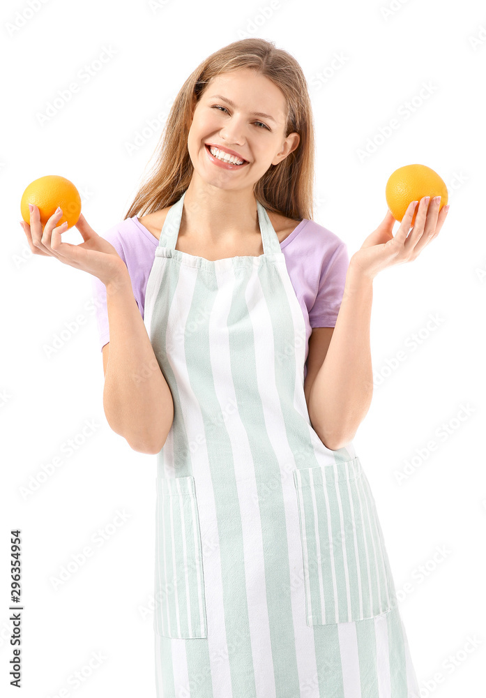 Beautiful young woman in apron and with oranges on white background Beautiful young woman in apron and with oranges on white background