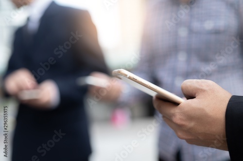 businessman uses a smartphone at sky walk.