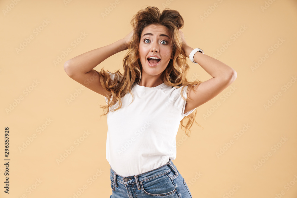 Portrait of joyous woman in casual clothes wondering and touching her hair Portrait of joyous woman in casual clothes wondering and touching her hair