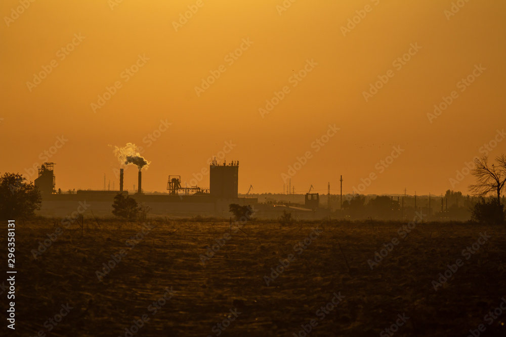 Fototapeta premium landscape with factory silhouette in sunset