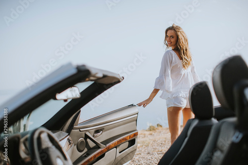 Pretty young woman by the w...