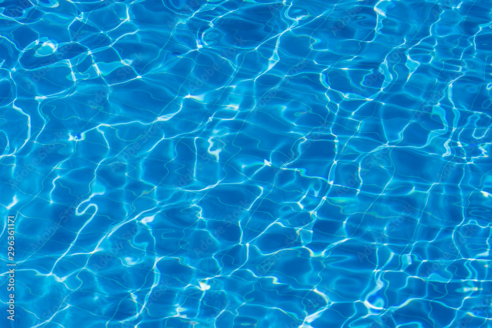 Water ripples on blue tiled swimming pool background. Top view