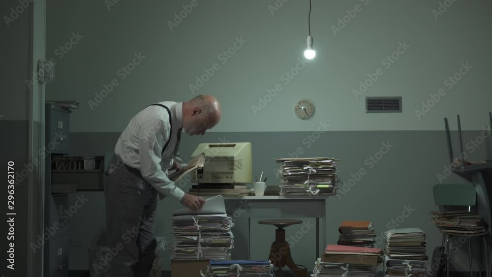 Disorganized businessman searching files in his office
