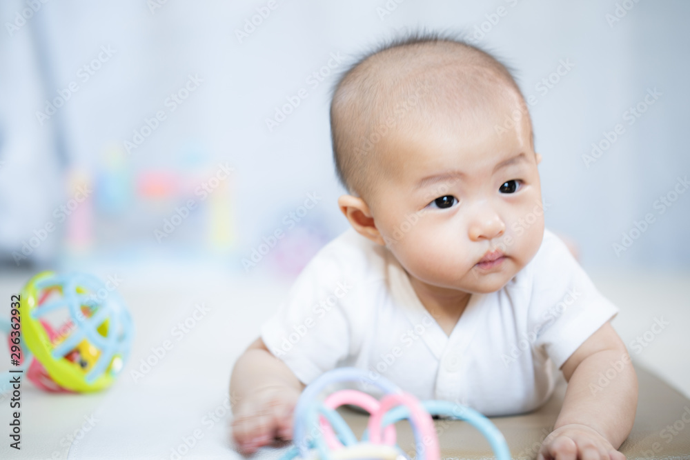 Asian baby happy in the room.Asian baby girl lying down on bed . Asian baby happy in the room.Asian baby girl lying down on bed .