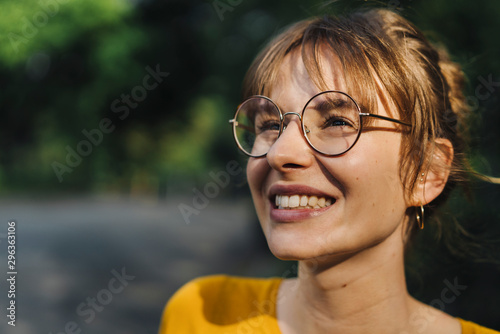 Portrait of smiling young woman with glasses photo