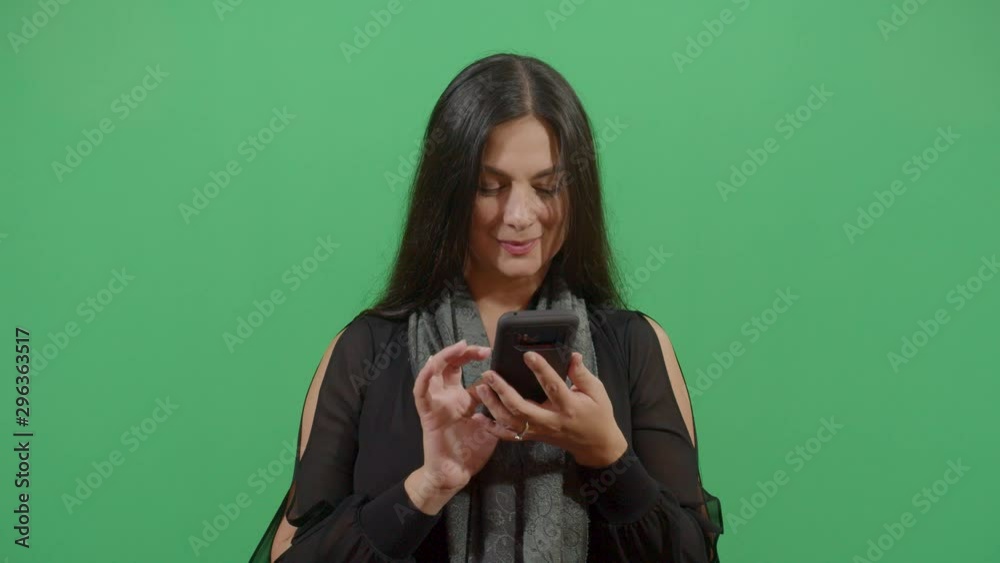 Woman Texting On A Mobile Phone With Great Hate. Studio Isolated Shot Against Green Screen Background Woman Texting On A Mobile Phone With Great Hate. Studio Isolated Shot Against Green Screen Background