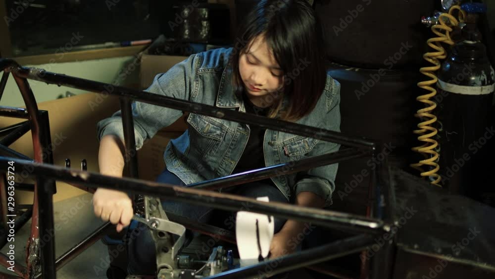 Asian engineer students are assembling and testing electric vehicles at ...