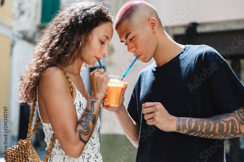 Young couple drinking fruit juice together