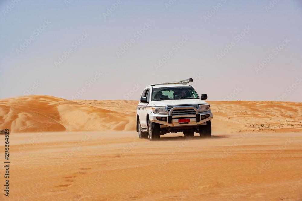 Tourist driving in desert in off-road vehicle, Wahiba Sands, Oman Tourist driving in desert in off-road vehicle, Wahiba Sands, Oman
