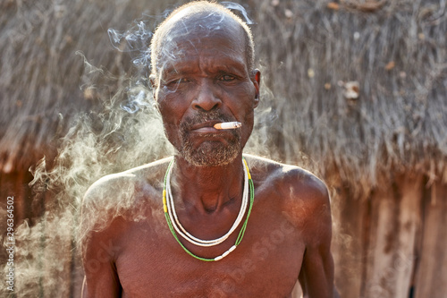 Traditional Mudimba tribe man smoking, Mudimba tribe, Canhimei, Angola