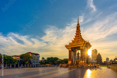 A Statue of King Father Norodom Sihanouk with blue and yellow sky in evening sunset background at central Phnom Penh, Capital of Cambodia. Beautiful cityscape of Cambodia.