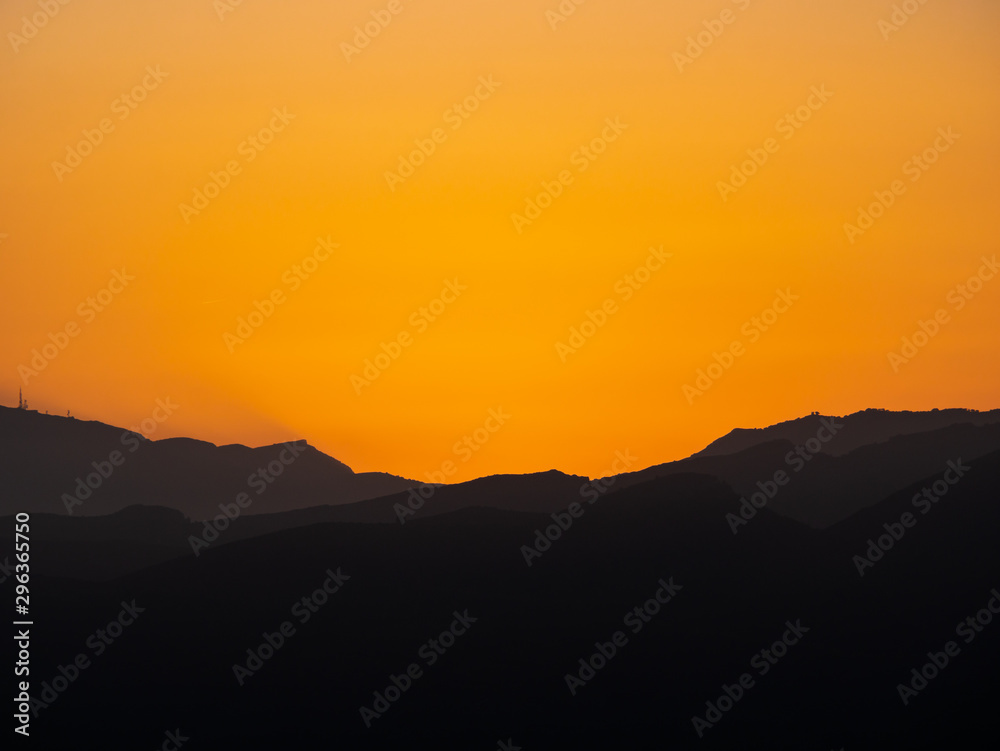  silhouette of mountains in the sunset with high contrast
