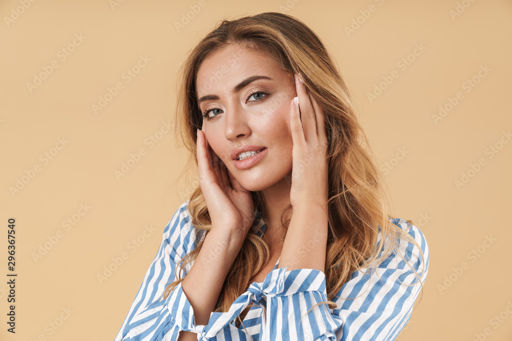 Image of feminine young woman smiling and looking at camera Image of feminine young woman smiling and looking at camera