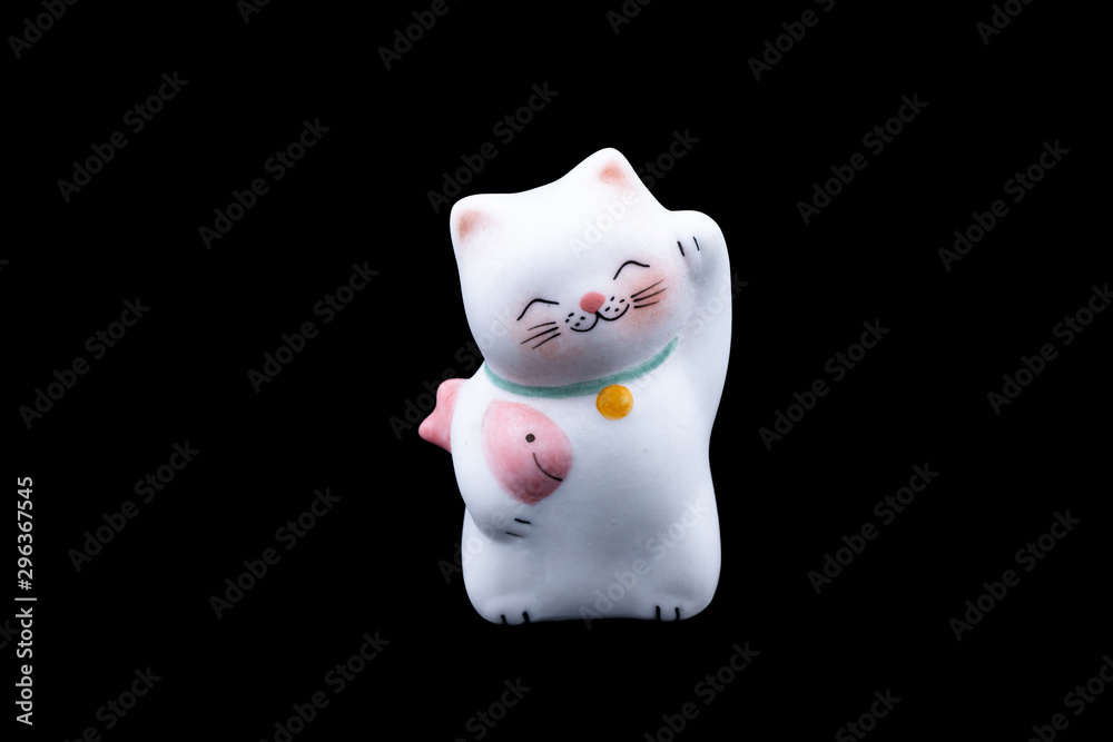 Cute lucky cat isolated on black background with clipping path
