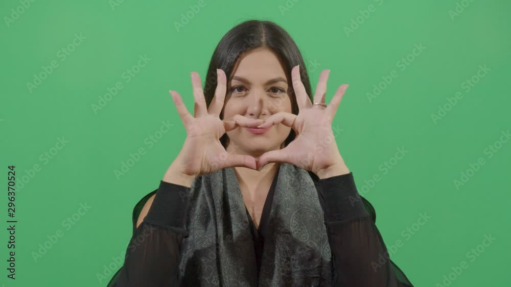 Hands Making A Heart By A Woman. Studio Isolated Shot Against Green Screen Background Hands Making A Heart By A Woman. Studio Isolated Shot Against Green Screen Background