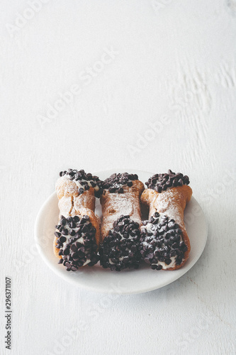 Italian chocolate chip cannoli sprinkled with powdered sugar