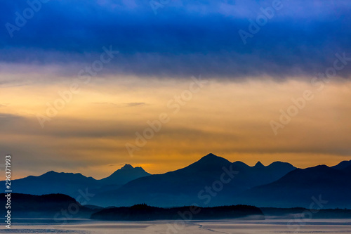 Sunset over Ocean and Mountains Silhouetted