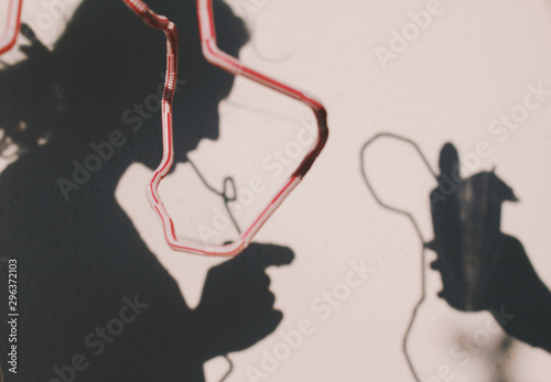 Close up of shadow of woman drinking cocktail with lengthy straw photo