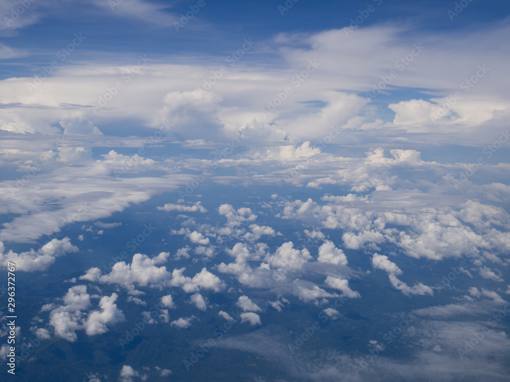 Clouds from airplane window with blue sky and high angle ground Clouds from airplane window with blue sky and high angle ground