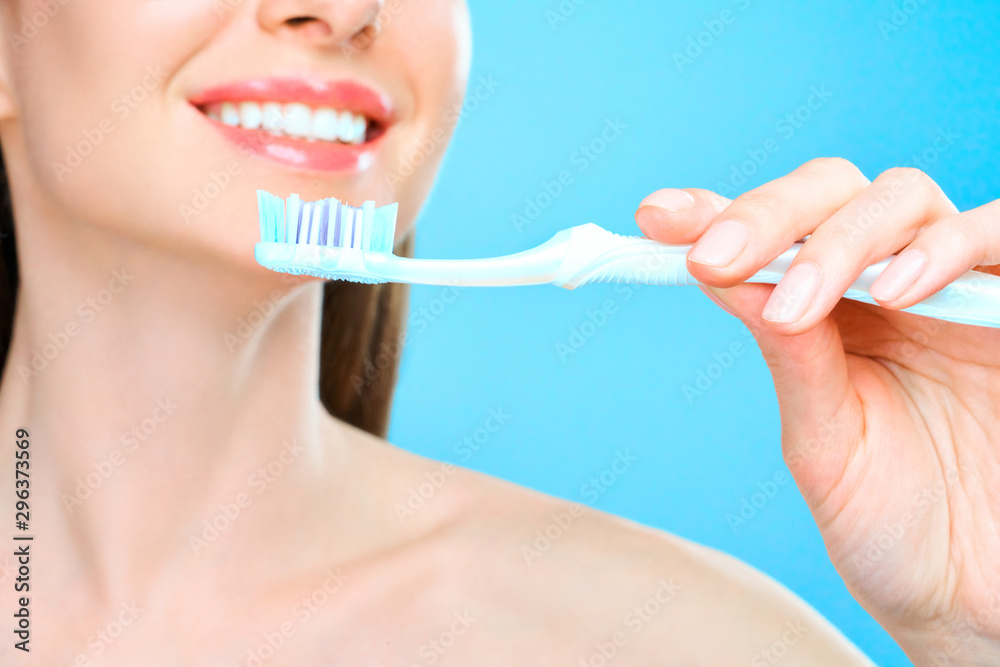 Young beautiful woman is engaged in cleaning teeth. Beautiful smile healthy white teeth. A girl holds a toothbrush. The concept of oral hygiene. Promotional image for a stomatology, dental clinic. Young beautiful woman is engaged in cleaning teeth. Beautiful smile healthy white teeth. A girl holds a toothbrush. The concept of oral hygiene. Promotional image for a stomatology, dental clinic.