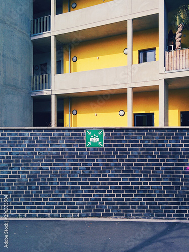 Apartment building and wall with evacuation sign