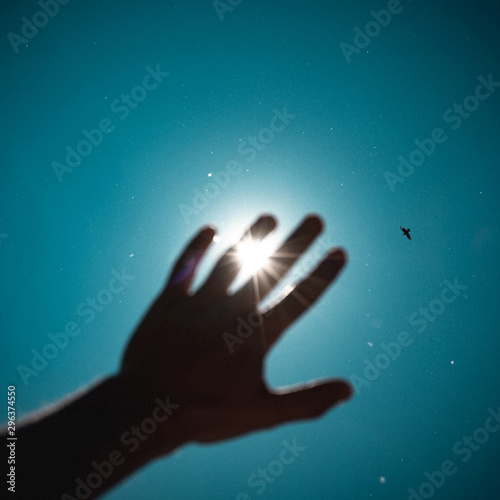 Close up of sun seen through man's hand