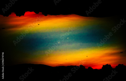 Silhouetted landscape against colorful sky