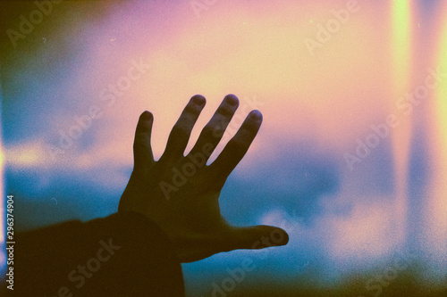 Close up of man's hand touching window glass