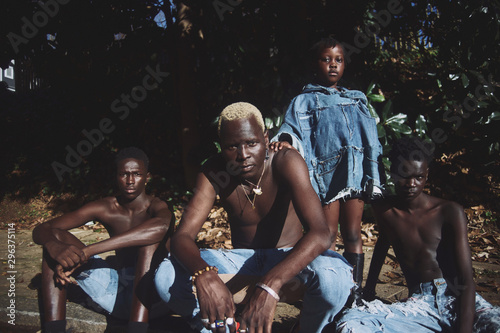 Portrait of family posing in torn jeans