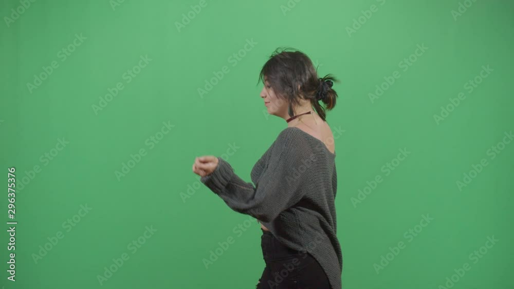 Woman Dancing Like Being In A Invisible Disco Or Just Having Good Time. Studio Isolated Shot Against Green Screen Background Woman Dancing Like Being In A Invisible Disco Or Just Having Good Time. Studio Isolated Shot Against Green Screen Background