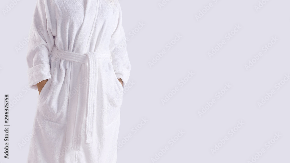 Midsection of a person in white copy-space bathrobe Midsection of a person in white copy-space bathrobe