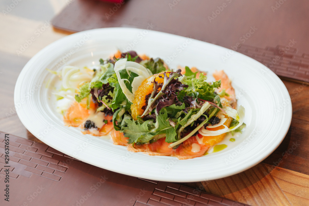 Smoked Salmon Pomelo Salad include green oak, red leaf lettuce and onion. Dressing with Thai spicy seafood salad sauce.