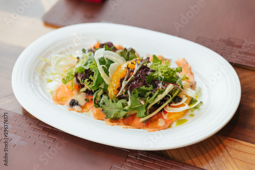 Smoked Salmon Pomelo Salad include green oak, red leaf lettuce and onion. Dressing with Thai spicy seafood salad sauce.
