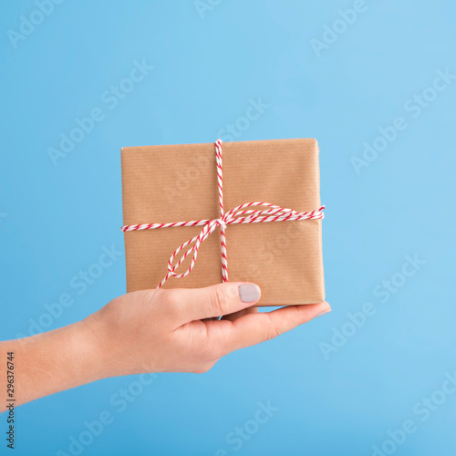 Close up of Holiday gift in box on woman hand