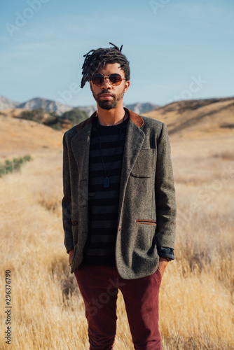 Portrait of man wearing suit jacket in field