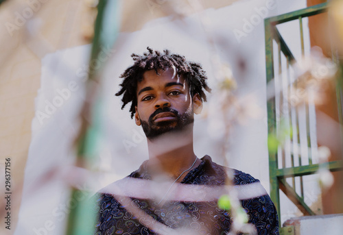 Portrait of man behind fence