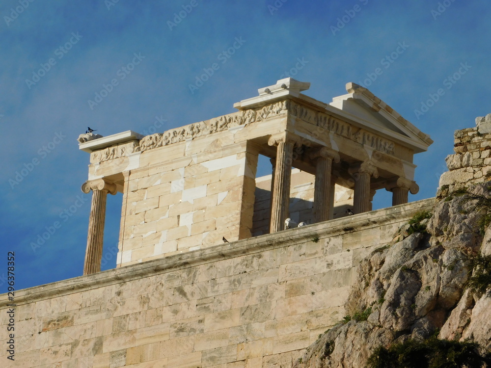 January 2019, Athens, Greece.  The ancient temple of Athena Nike, in the Acropolis, and Eurasian magpies or pica pica birds