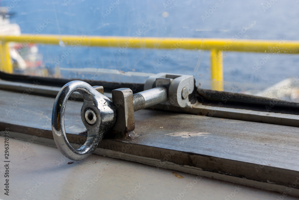 Locking srew for water tight window of a construction barge at oil field Locking srew for water tight window of a construction barge at oil field
