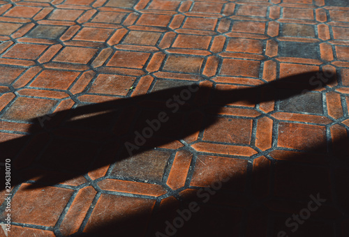 Shadow of man falling on paving stone