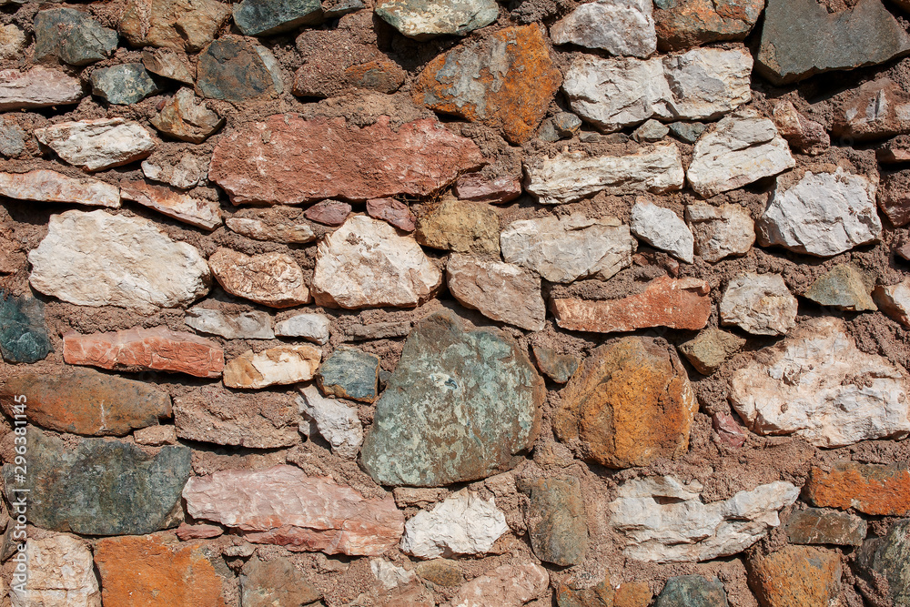 Fototapeta premium Antique gray stone wall framed by red brick. Turkish masonry.