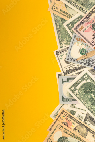 One hundred dollar banknotes on colored background top view, with empty place for your text business money concept.