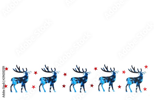 Christmas and New Year background with blue silhouette deer and reds stars confetti. Holiday symbols on white background. Copy space.