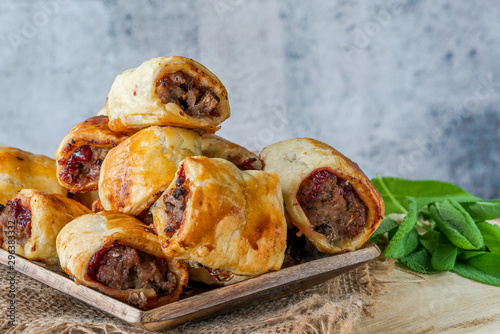 Bild auf Leinwand Homemade sausage, cranberry, chestnut and sage rolls