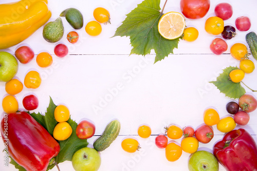 Background with vegetables. Vegetables on a white background wood texture top view. Tomatoes cucumbers peppers apples. Proper nutrition and diet. Concept of vegetarianism and detox.