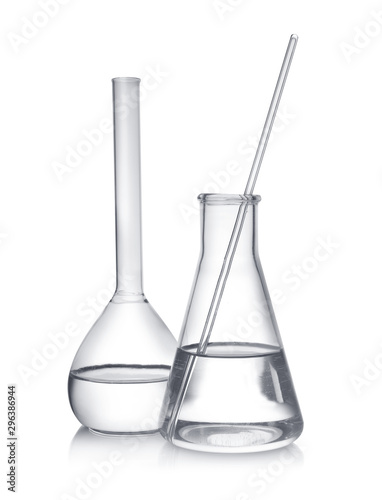 Laboratory glassware with liquid samples on white background