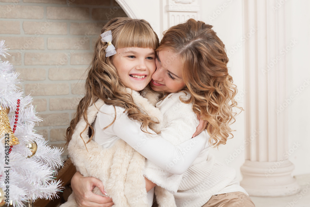 Mother and daughter, Christmas tree, gifts and toys Mother and daughter, Christmas tree, gifts and toys