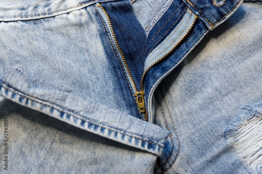 Trendy stylish jeans frayed and torn in different places.