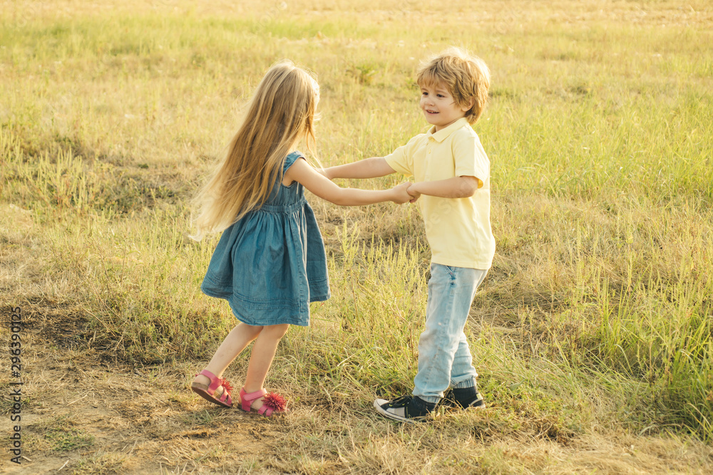 Kids play in autumn park. Children in autumn. Child playing - Happy childhood. Toddler kids or preschooler child in fall. Kids play in autumn park. Children in autumn. Child playing - Happy childhood. Toddler kids or preschooler child in fall.